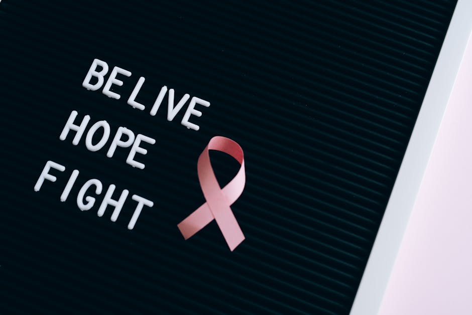 Inspirational breast cancer awareness message on a letter board with a pink ribbon.