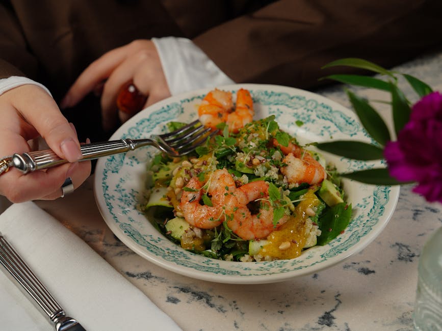 A delicious shrimp salad with mixed greens, quinoa, and vibrant colors, perfect for a healthy meal.