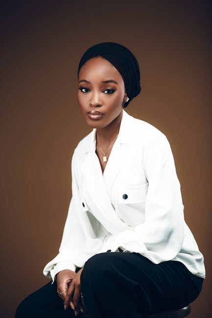 Stylish portrait of a young woman in a studio setting showcasing modern elegance and fashion.