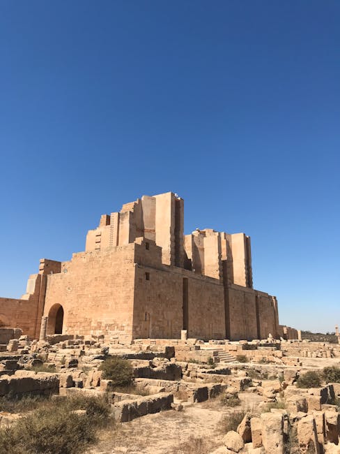 Majestic ancient ruins basking under a clear blue sky, showcasing historical architecture.