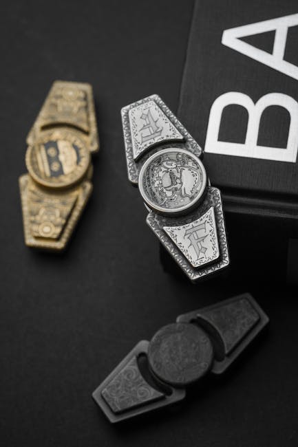 Stylish metallic fidget spinners in silver, gold, and black hues on a dark background for relaxation and focus.