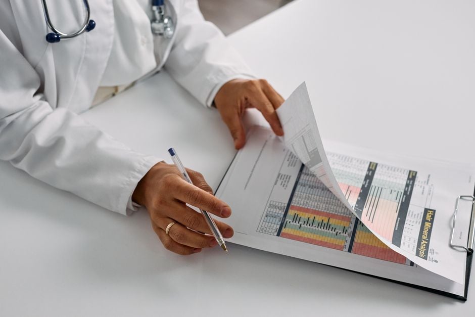 doctor reviewing genomic report and prescription Paxlovid
