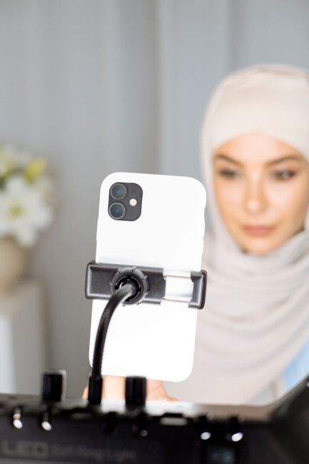 close-up hands editing short educational video on smartphone Arabic creator