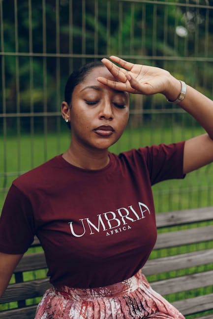 Stylish portrait of an African woman in Nigeria, showcasing vibrant fashion in an outdoor setting.