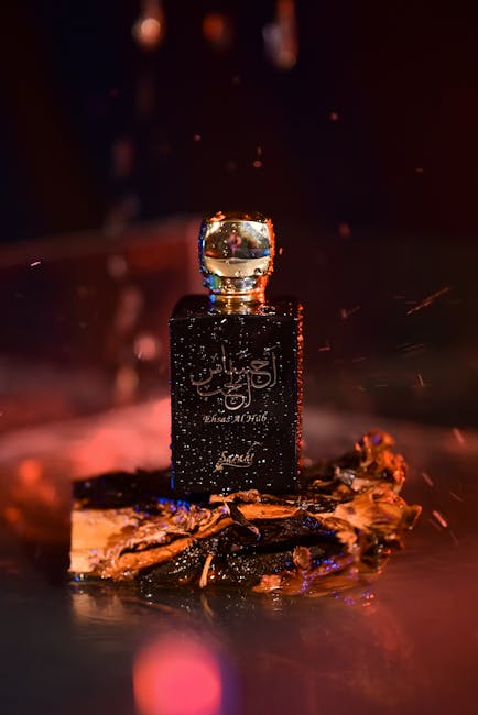 Luxurious perfume bottle with wood base in a dramatic, warm setting.