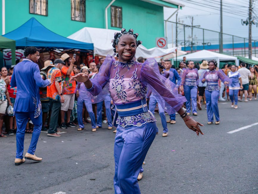 Vibrant street parade in Limón, Costa Rica, featuring colorful costumes and joyful dance performances.