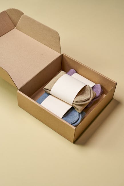Minimalist cardboard box with colorful eco-friendly socks on neutral background.