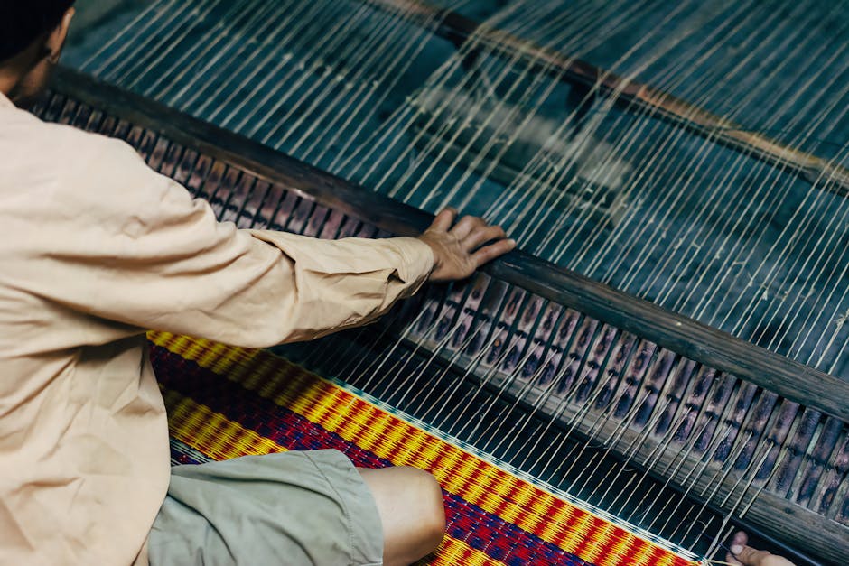 A craftsman weaving on a loom in Hội An, showcasing traditional textile production.