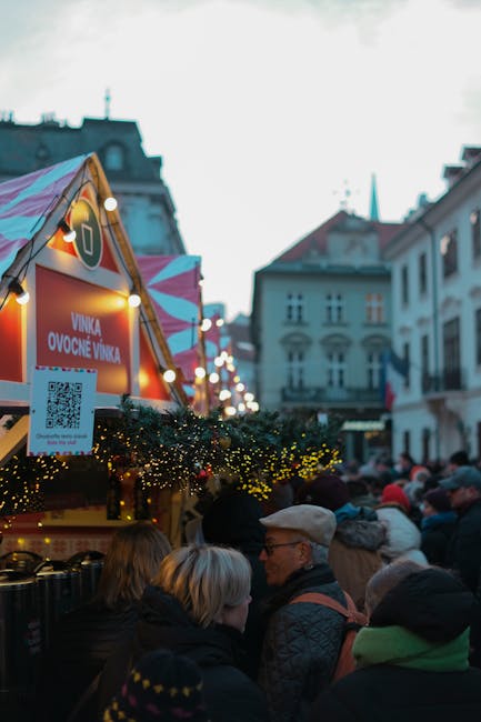 Experience the festive vibe at Bratislava's Christmas market with bustling crowds and decorated stalls.