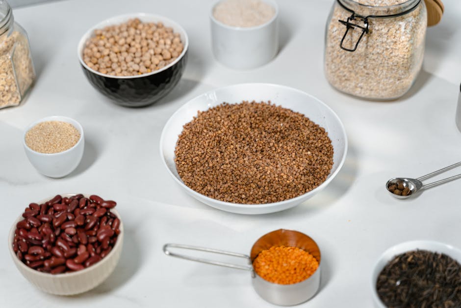 A collection of grains and legumes in various bowls and jars, perfect for culinary inspiration.