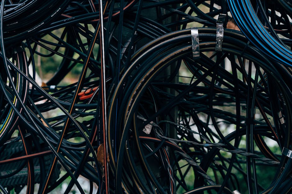 Close-up view of a complex tangle of electrical wires outdoors.