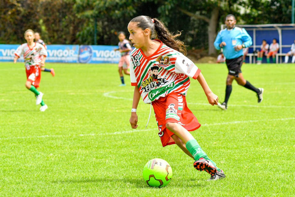 youth football academy coach with players on pitch training close up