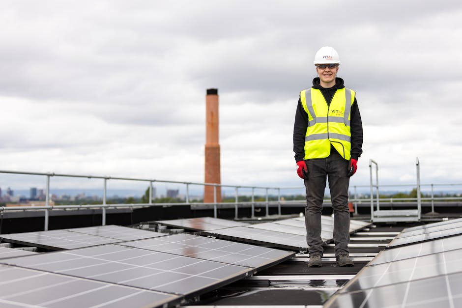 An engineer in a hard hat and safety vest inspects solar panels on a rooftop.