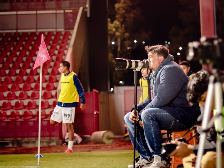 coach reviewing match footage laptop sidelines pexels