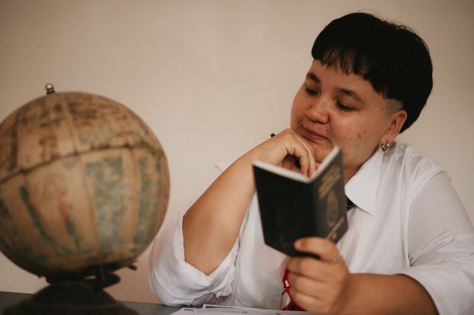Nepali student with passport laptop study planning abroad