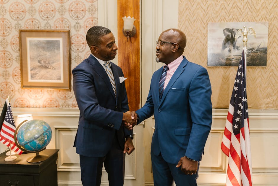 two professionals negotiating salary office handshake Pexels
