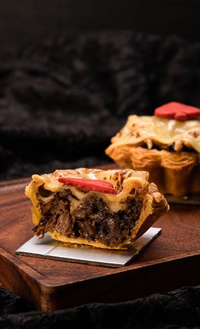 Close-up of a homemade beef pie slice with a flaky crust, perfect for rustic dining.