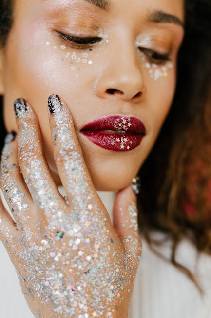 Close-up portrait of a woman with glitter makeup and red lipstick, showcasing modern beauty trends.
