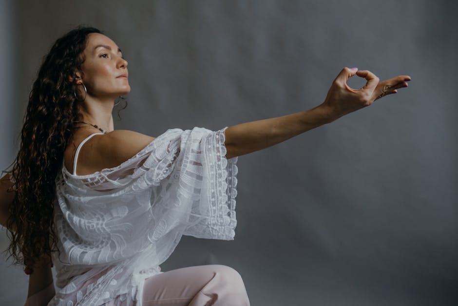 Woman practicing yoga pose with graceful expression indoors.