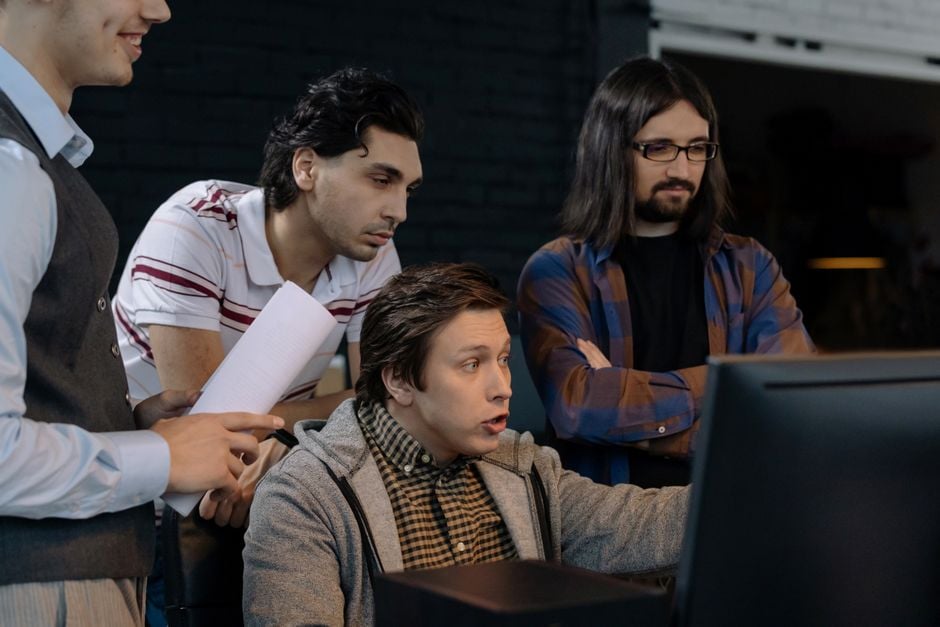 Arab game developers team meeting computers brainstorming