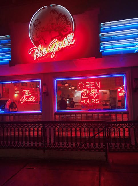 Iconic diner in Athens, GA, lit by vibrant neon signage displaying 'Open 24 Hours.'