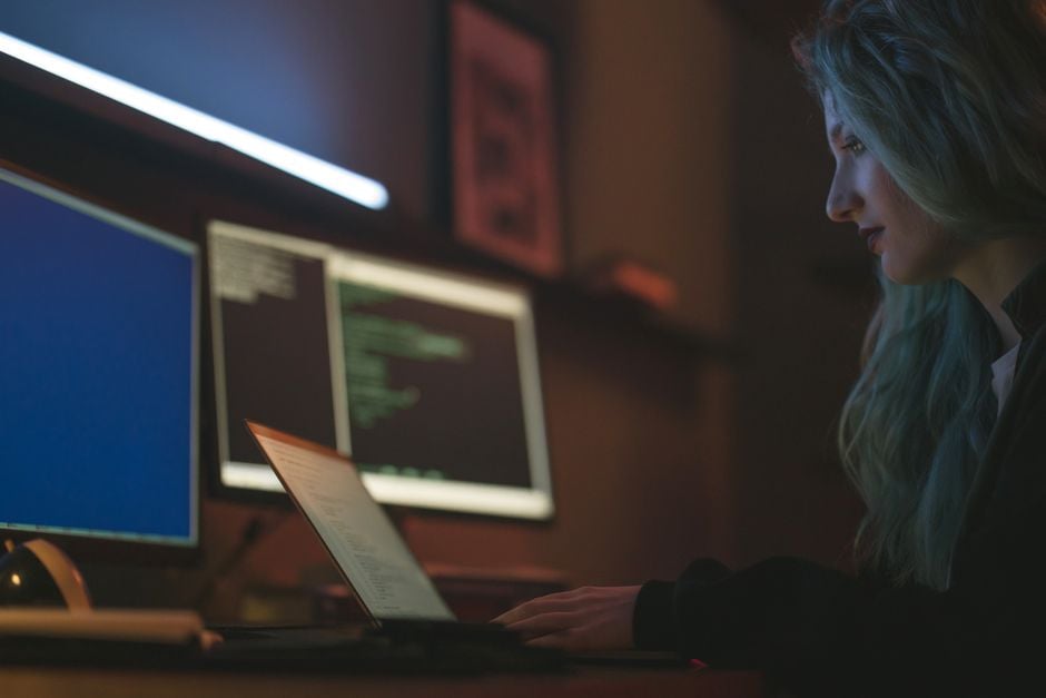 cybersecurity developer monitoring multiple monitors code SBOM CI pipeline