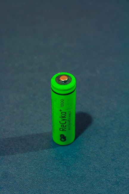 Vertical close-up of a green rechargeable battery highlighting power and sustainability.