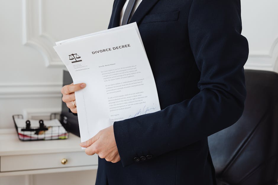 A person holding a divorce decree in an office setting, symbolizing legal proceedings.