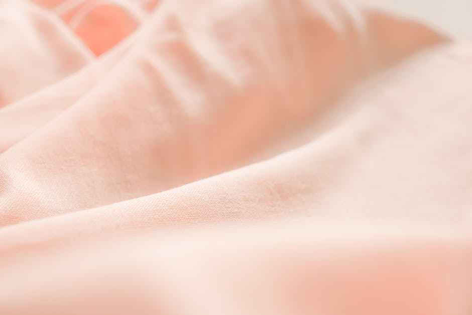 close-up cotton sheets texture soft weave natural light bedroom