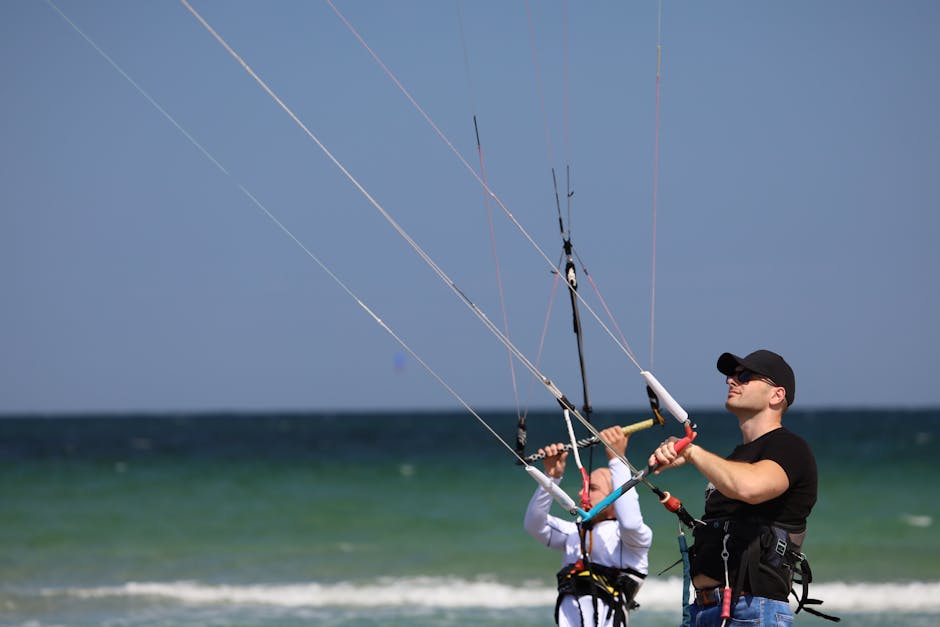 Two adults engaged in kitesurfing, capturing the thrill and excitement of the sport.