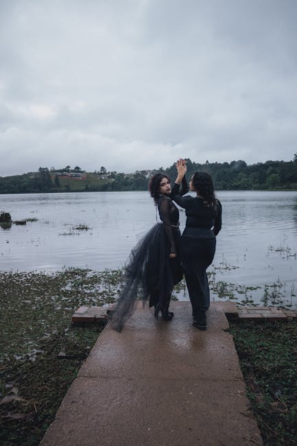 Couple dancing on a misty lakeside pier, exuding romance and mystery.