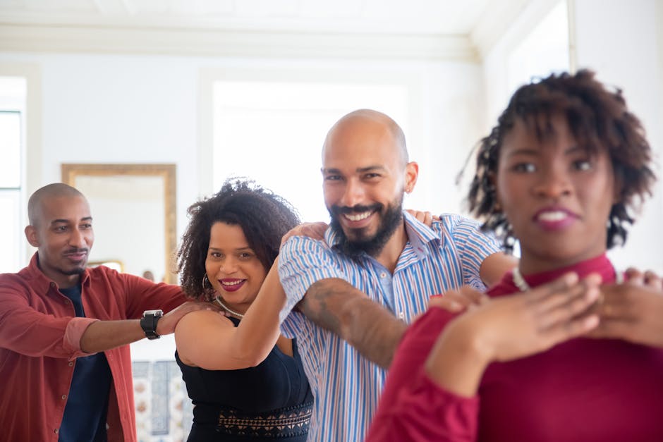 A happy group of friends dancing indoors, celebrating friendship with joy and smiles.