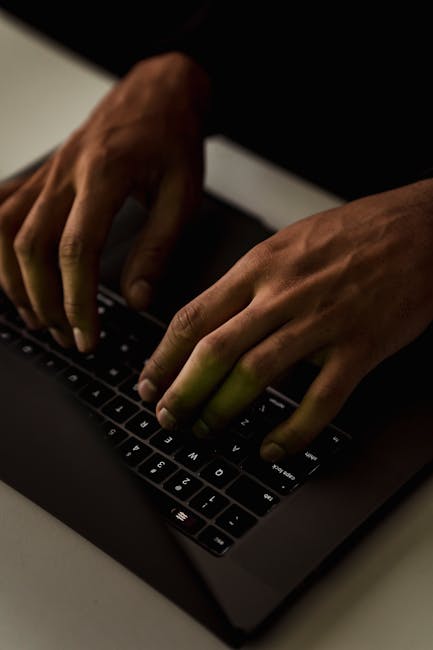 hands typing on laptop dark room web pentest terminal