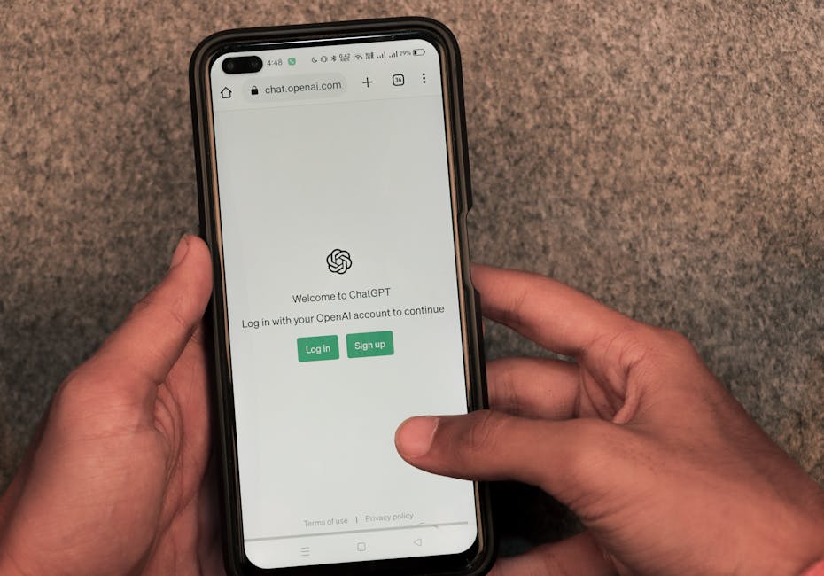 Close-up of hands using smartphone with ChatGPT app open on screen.