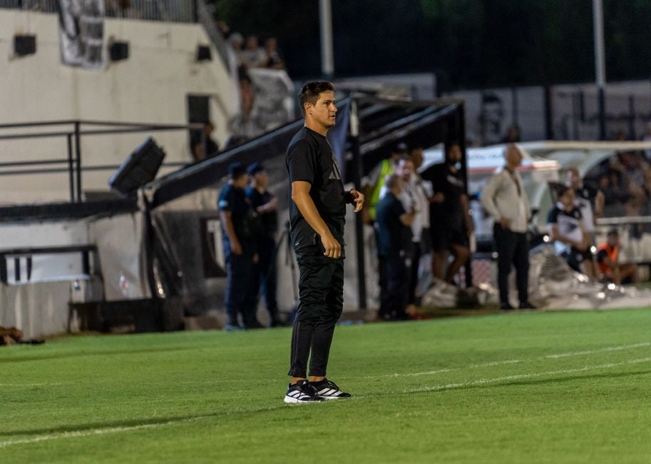 coach analyzing match data laptop stadium night