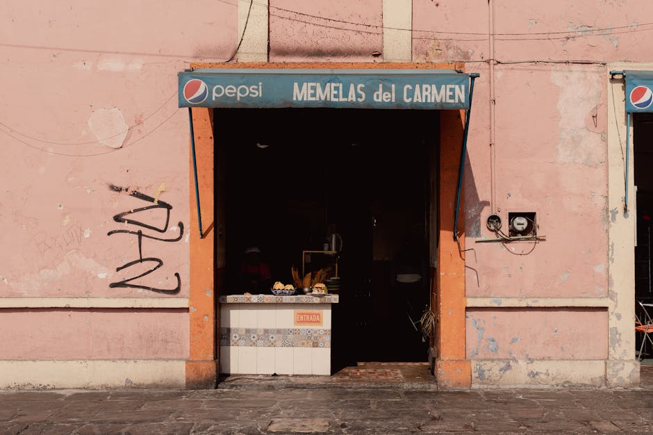 Vintage storefront of Memelas del Carmen in Puebla, Mexico, with vibrant colors and urban charm.