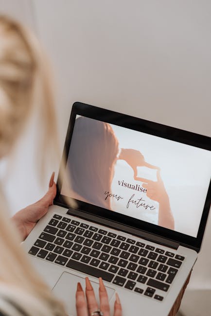 Woman viewing inspirational message on laptop screen indoors.