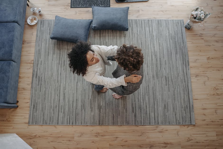 couple practicing dance in small living room barefoot smiling