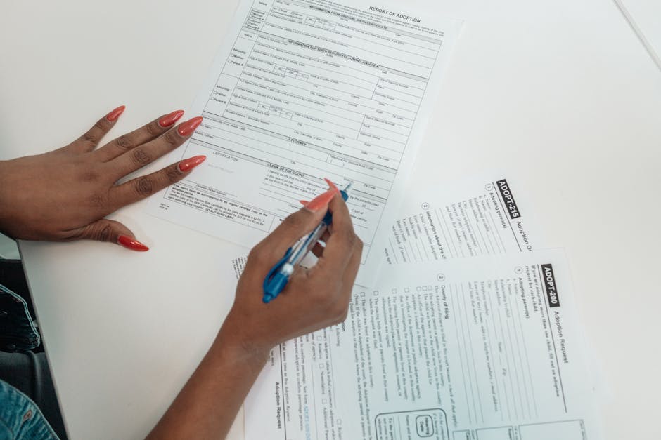 candidate filling application form at desk government office