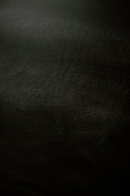 A textured dark chalkboard background, perfect for design projects.