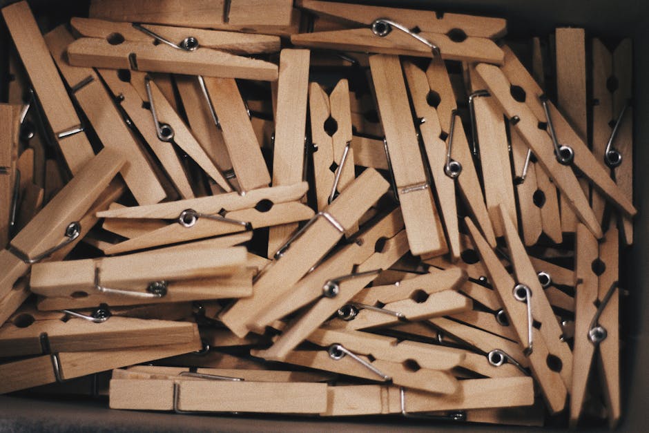 A detailed close-up of a collection of wooden clothespins in a box.