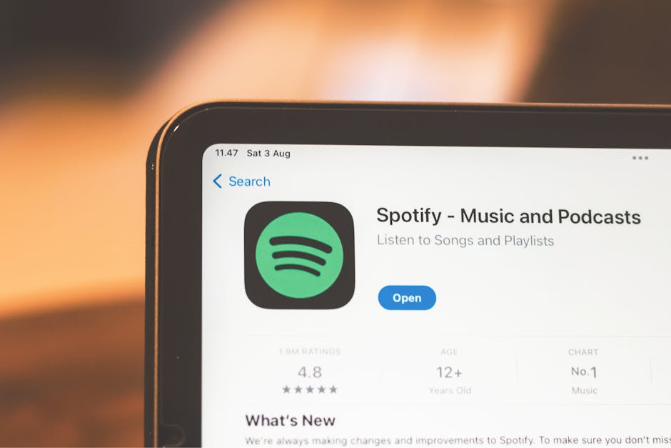 Close-up of Spotify app page displayed on a tablet screen, highlighting its features.