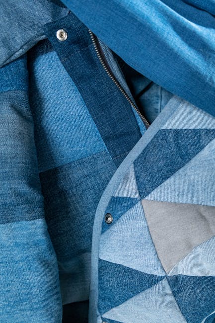 Detailed view of blue denim patchwork fabric showcasing texture and pattern.