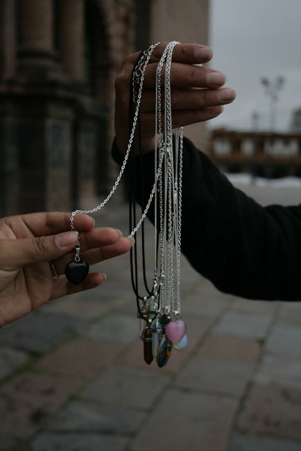 Close-up of hands exchanging necklaces in Cusco, blending artisanal charm with cultural elegance.