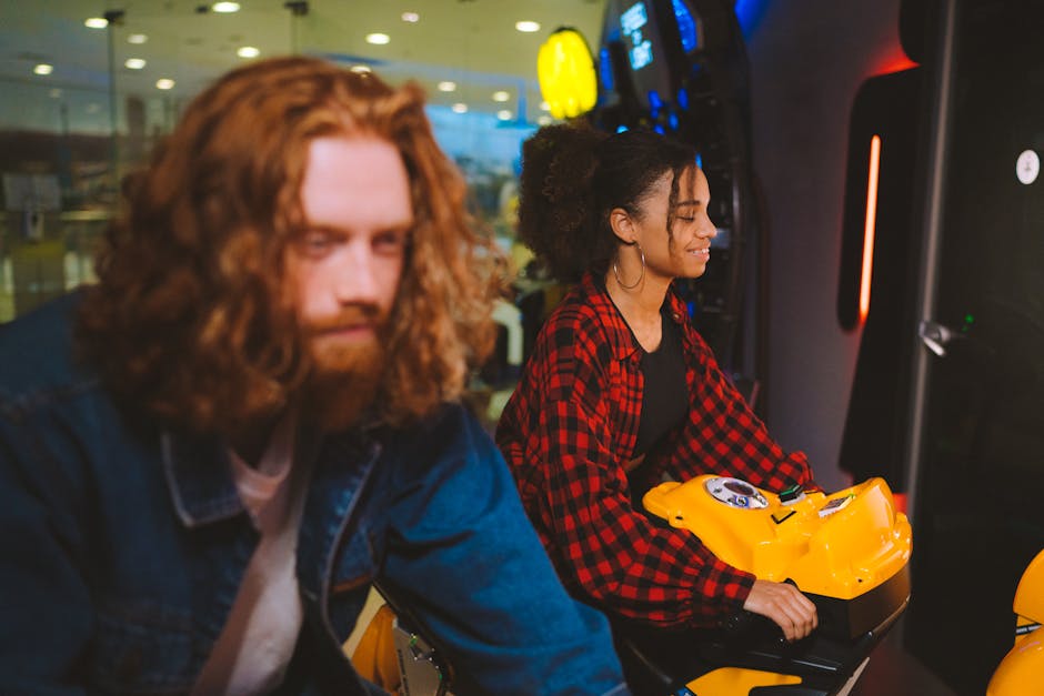 A couple having fun on motorbike arcade machines at an entertainment center.
