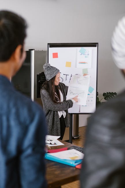 woman pitching startup presentation laptop investors modern office confident