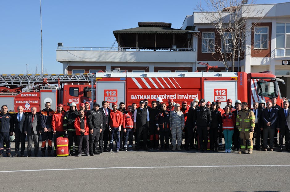 Group of firefighters and officials posing in front of a fire truck in Batman, Türkiye.