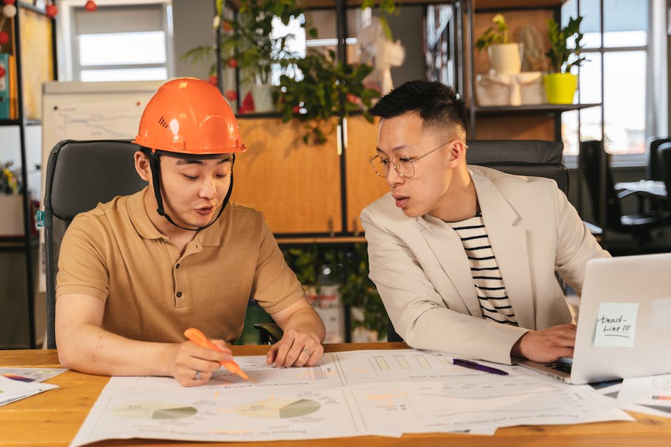 engineers reviewing SLA contract laptop meeting