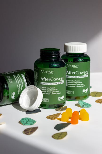Green supplement bottles labeled 'AfterCoweed' with gummies and leaves on a white surface