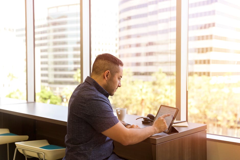 remote freelancer desk laptop city skyline UAE skyline coffee